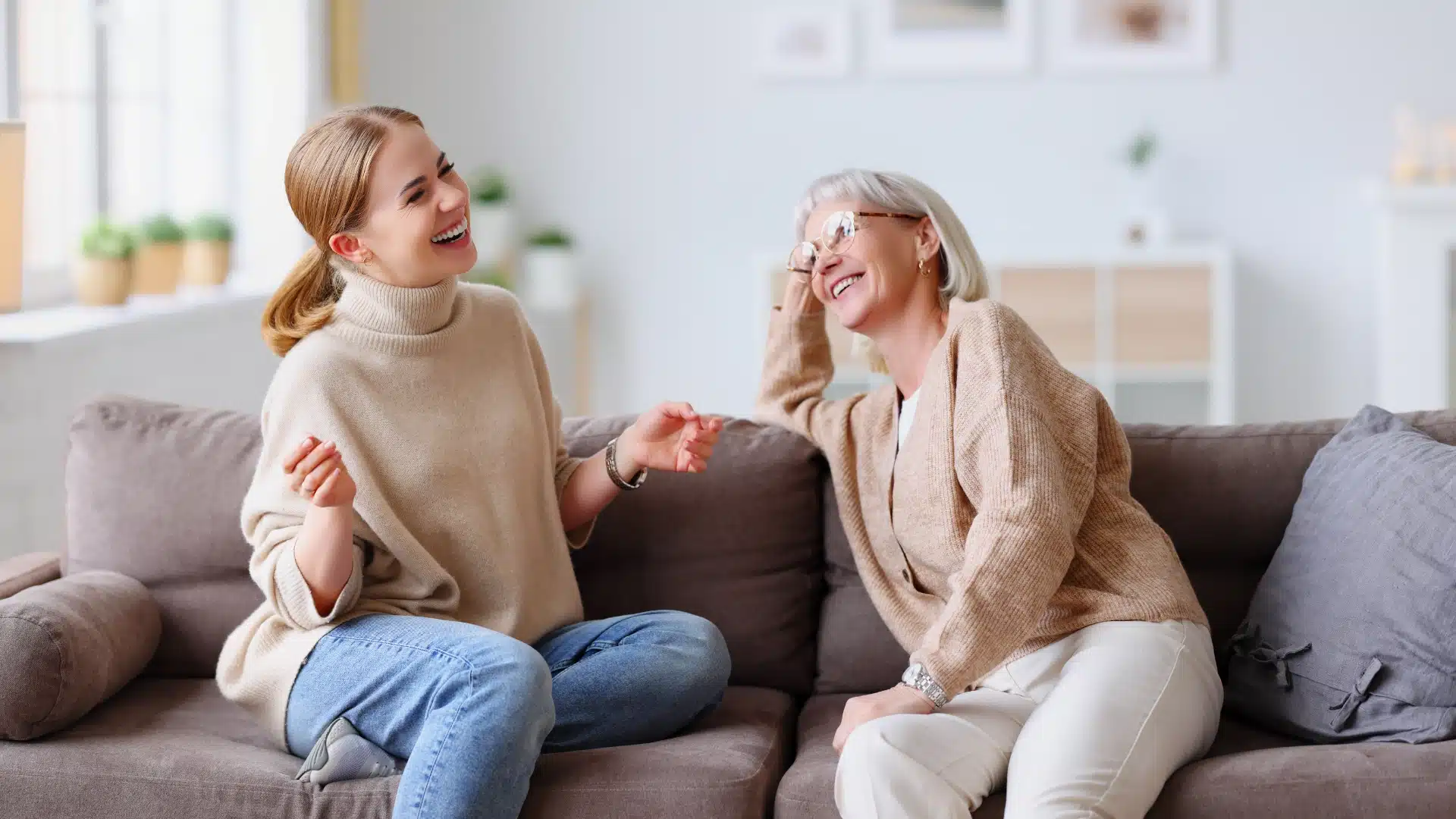 Two women laughing during a therapy session