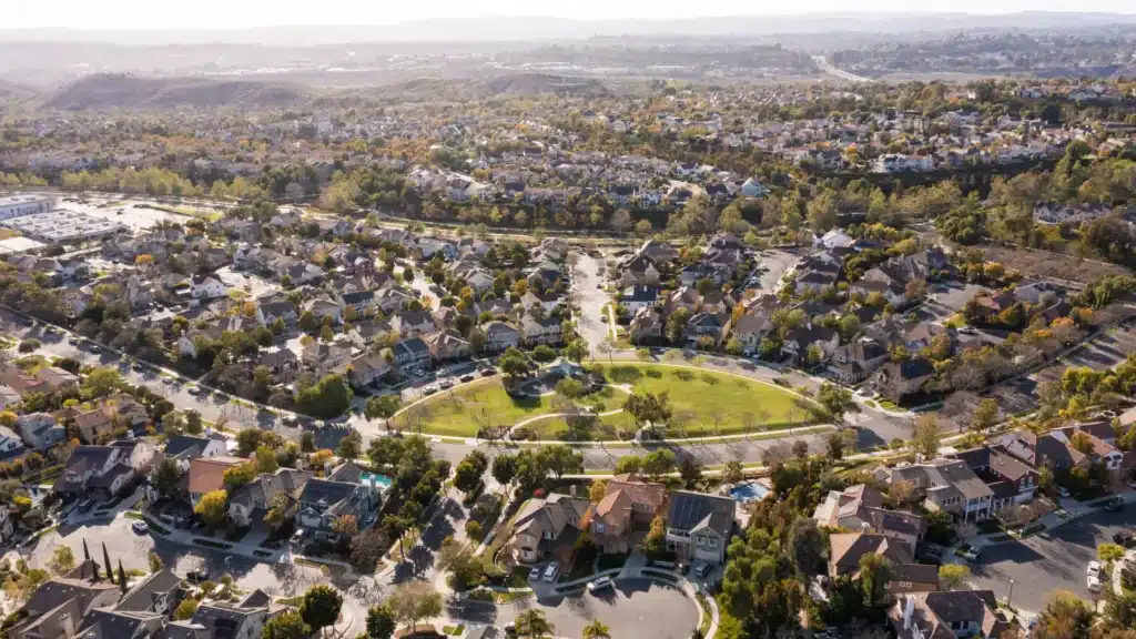 Aerial view of Ladera Ranch, California showing residential neighborhoods, green park space, and surrounding streets.