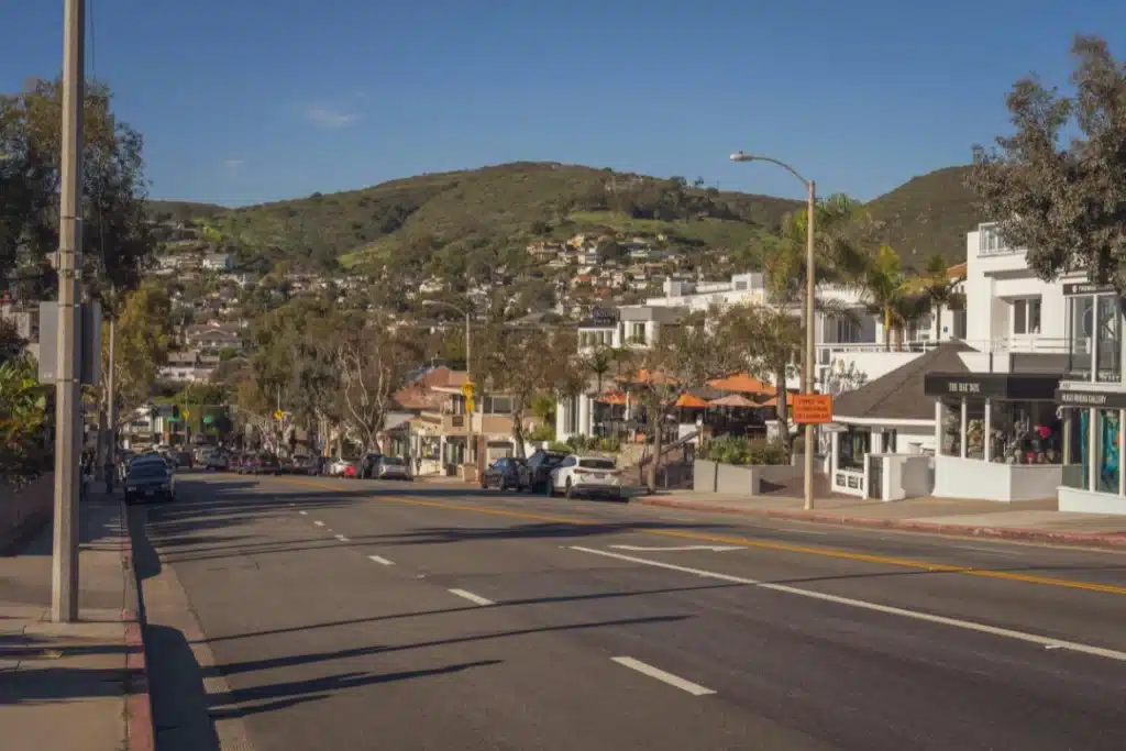 Laguna Hills street view with suburban homes and surrounding hills under clear skies