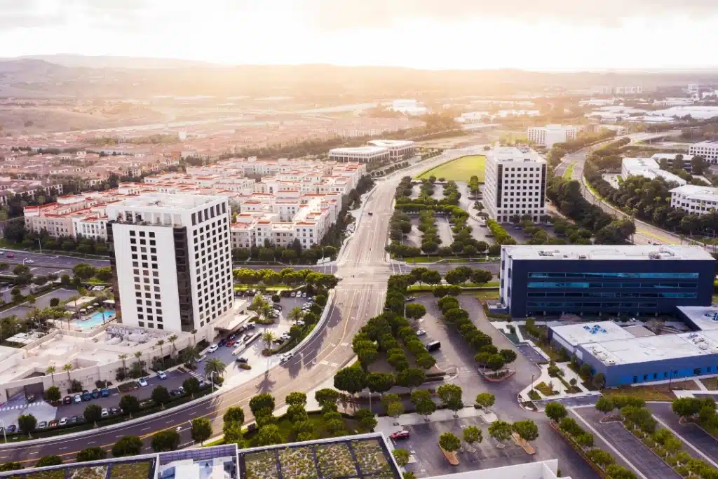 Scenic view of Irvine featuring landscaped neighborhoods, green spaces, and contemporary buildings in a bright, sunny setting